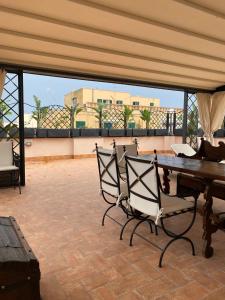 a patio with a table and chairs on a balcony at Regal House Anzio Terrazzo in Anzio