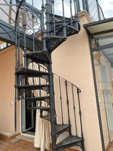 a black spiral staircase on the side of a building at Regal House Anzio Terrazzo in Anzio