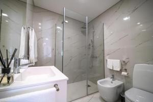 a white bathroom with a sink and a shower at FERREIRA'S HOUSE Guimarães in Guimarães +78 photos