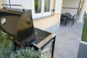 a barbecue grill sitting outside of a house at Ponent 602 in Marina Portorož by Locap Group in Portorož