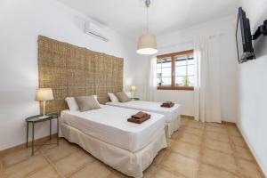 a bedroom with two beds and a flat screen tv at Villa 21 in Puerto del Carmen +50 photos