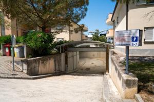 a small tunnel with a sign in front of a building at Ponent 602 in Marina Portorož by Locap Group in Portorož