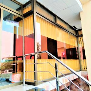 a glass building with a staircase in front of it at Hotel Vista Inn DHA in Rawalpindi