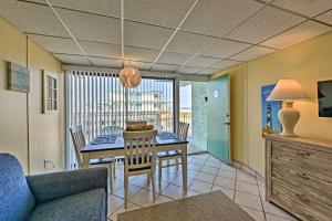 a dining room and living room with a table and chairs at Wildwood Crest Condo with Pool Walk to Restaurants! in Wildwood Crest