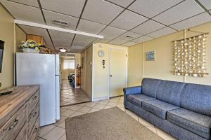 a living room with a couch and a refrigerator at Wildwood Crest Condo with Pool Walk to Restaurants! in Wildwood Crest