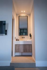 a bathroom with a sink and a mirror at Acron Athens in Athens +49 photos