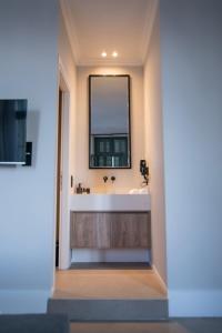 a bathroom with a sink and a mirror at Acron Athens in Athens
