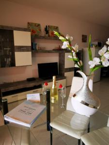 a glass table with a bottle of wine and a book at Ocean View Apartment in Adeje