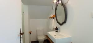 a white bathroom with a sink and a mirror at Pipo People House in Óbidos +46 photos