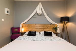 a bedroom with a large bed with a wooden headboard at Alaburic rooms & apartment in Mali Lošinj