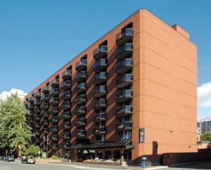 a brick building with balconies on the side of it at Cartier Place Suite Hotel in Ottawa