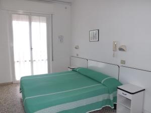 En eller flere senge i et værelse på Hotel Villa Domiziana