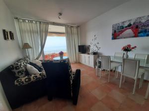 a living room with a couch and a table at Expoholidays-Ático primera línea Aguadulce in Aguadulce