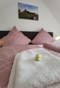 a stuffed animal sitting on top of a bed at Winterberg Centrum mit privaten Ski Keller in Winterberg