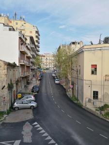 an empty city street with cars parked on the side at B&B Reale - Ortona in Ortona