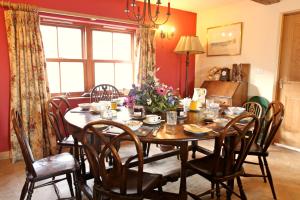 a dining room with a table and chairs at Knockaloe Beg Farm in Patrick