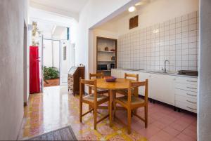 a kitchen with a table and chairs in a room at Pensión Bellavista in Port de Pollensa