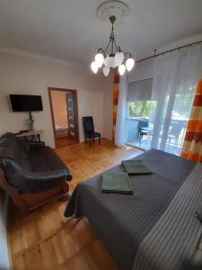 Posteľ alebo postele v izbe v ubytovaní Zöld Sziget Apartmanlakás