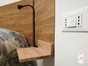 a bedside table with a lamp next to a couch at B&B Reale - Ortona in Ortona