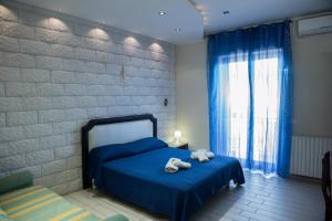 a bedroom with a blue bed with towels on it at B&B S Home in Naples