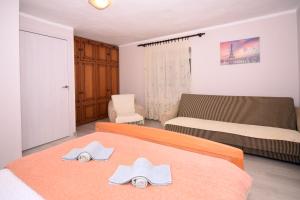 a bedroom with a bed with two towels on it at Village house Borozan in Cetinje