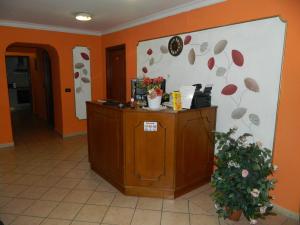 a room with orange walls and a counter with flowers on the wall at Roxena house in Rome