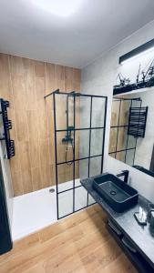 a bathroom with a shower and a sink in it at Labar Apartments in Gdańsk