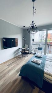 a living room with a bed and a dining room at Labar Apartments in Gdańsk
