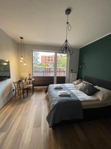 a bedroom with a large bed and a table at Labar Apartments in Gdańsk
