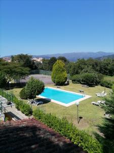 an image of a swimming pool in a yard at Quinta Do Fijo in Arcos de Valdevez