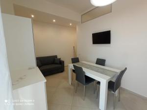 a kitchen and dining room with a table and chairs at Royal View Apartment in Cefalù