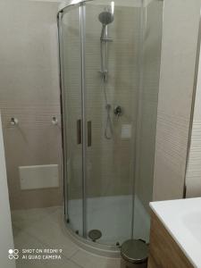 a shower with a glass door in a bathroom at Royal View Apartment in Cefalù