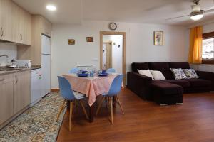 a kitchen and a living room with a table and chairs at Bellavista 2 in Alquézar