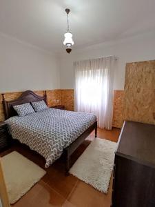 En eller flere senge i et værelse på Casa da Tia Maria