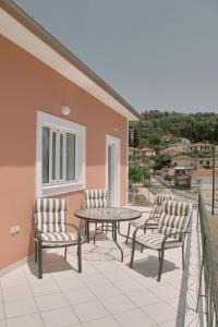 een patio met stoelen en een tafel op een balkon bij Villa Ancient Olympia by PCL in Pelópion
