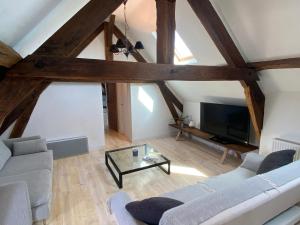 a living room with a couch and a tv at Maison de Haouret in Libaros