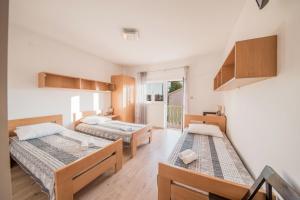 een kamer met 2 bedden en een raam bij Apartment Prominac in Zadar