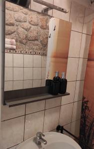 a bathroom with a sink and a mirror on a wall at Romantic Apartment Sonja, Beachfront in Cesarica +79 photos