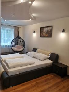 a bedroom with a bed with a hanging basket at Apartament Rycerka Górna in Rycerka Górna