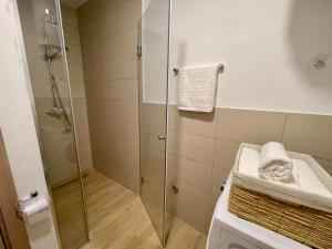 a shower with a glass door in a bathroom at Olive Square Apartment Budva in Budva +19 photos
