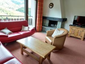 a living room with a couch and a table and a fireplace at Haus Duranna - Arosa Rocks in Arosa