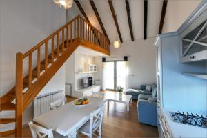 a living room with a staircase and a white table at Žakan in Murter