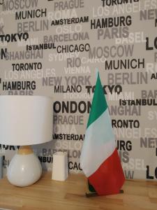 two vases sitting on a table next to a lamp at Hotel Malta in Milan