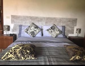 a bed with pillows on it in a bedroom at La Tosca in Laiatico