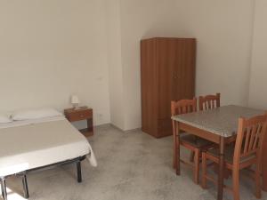 a bedroom with a bed and a table and chairs at La Marina Bay in Vieste