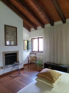 a bedroom with a bed and a fireplace at Villa Rustico in Viboldone +39 photos