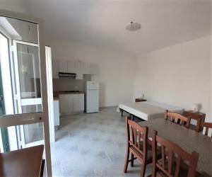 a kitchen and dining room with a table and chairs at La Marina Bay in Vieste