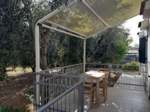 a patio with a table and chairs under a canopy at La Marina Bay in Vieste