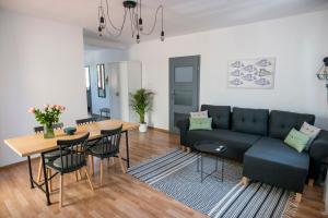 a living room with a couch and a table at Apartamenty Centrum Biskupiec in Biskupiec