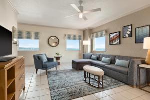 a living room with a couch and a tv at Holiday Inn & Suites Ocean City by IHG in Ocean City +144 photos